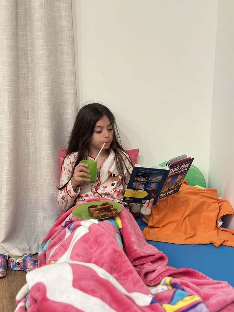 Alina reading Dog Man at home